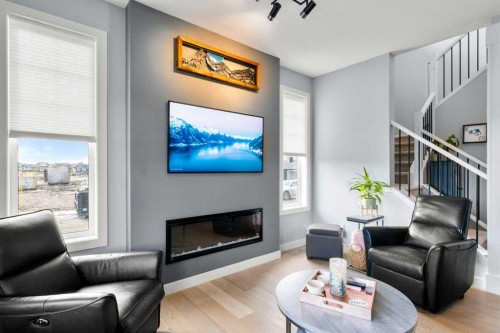 3 Sundown Manor, Cochrane, AB - Indoor Photo Showing Living Room With Fireplace
