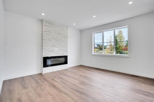 75 Sunvalley Way, Cochrane, AB - Indoor Photo Showing Living Room With Fireplace