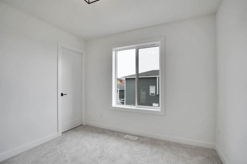 75 Sunvalley Way, Cochrane, AB - Indoor Photo Showing Other Room