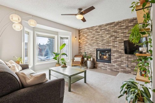 3406 Cedarille Drive Sw, Calgary, AB - Indoor Photo Showing Living Room With Fireplace