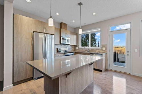 251 Sunrise View, Cochrane, AB - Indoor Photo Showing Kitchen With Upgraded Kitchen
