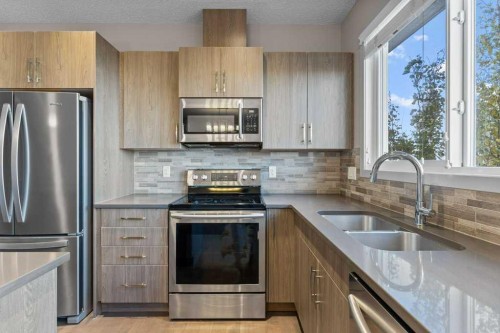 251 Sunrise View, Cochrane, AB - Indoor Photo Showing Kitchen With Double Sink With Upgraded Kitchen