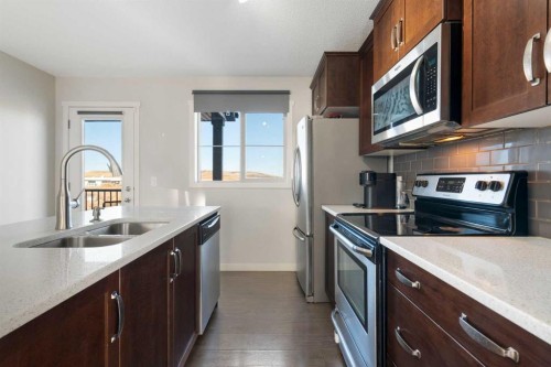 325 Copperpond Landing Se, Calgary, AB - Indoor Photo Showing Kitchen With Stainless Steel Kitchen With Double Sink With Upgraded Kitchen