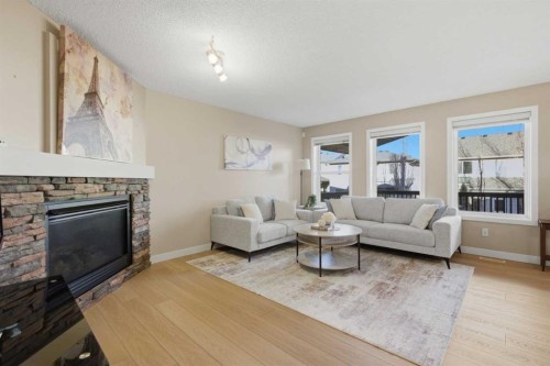 227 Panamount Circle Nw, Calgary, AB - Indoor Photo Showing Living Room With Fireplace