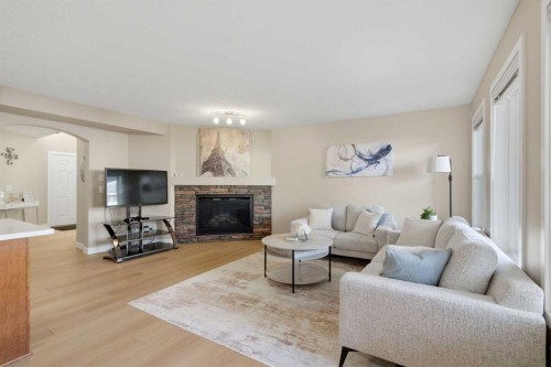 227 Panamount Circle Nw, Calgary, AB - Indoor Photo Showing Living Room With Fireplace