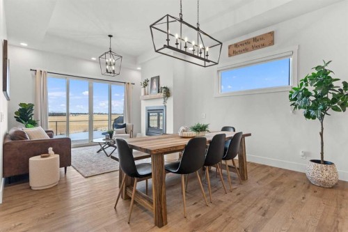 79 Sandpiper Bend, Chestermere, AB - Indoor Photo Showing Dining Room With Fireplace