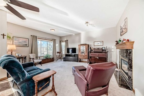 114 Royal Birkdale Crescent Nw, Calgary, AB - Indoor Photo Showing Living Room With Fireplace