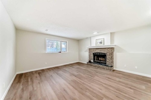 624 Shawinigan Drive Sw, Calgary, AB - Indoor Photo Showing Living Room With Fireplace