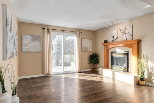 3 Hawkcliff Way Nw, Calgary, AB - Indoor Photo Showing Living Room With Fireplace