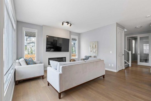 79 Sunrise Way, Cochrane, AB - Indoor Photo Showing Living Room With Fireplace
