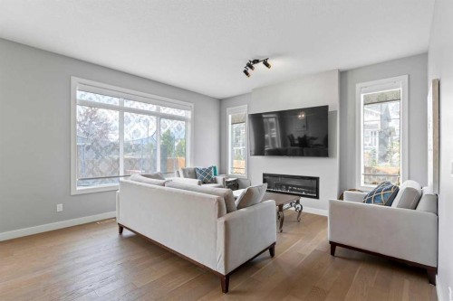 79 Sunrise Way, Cochrane, AB - Indoor Photo Showing Living Room With Fireplace