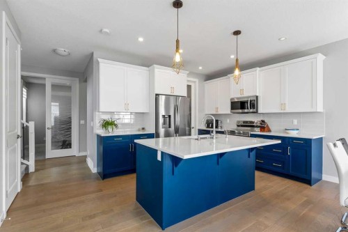 79 Sunrise Way, Cochrane, AB - Indoor Photo Showing Kitchen With Double Sink With Upgraded Kitchen