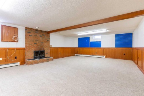 1008 Shawnee Drive Sw, Calgary, AB - Indoor Photo Showing Other Room With Fireplace