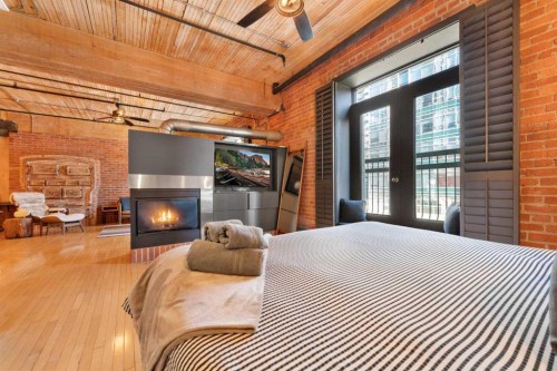305-535 10 Avenue Sw, Calgary, AB - Indoor Photo Showing Bedroom With Fireplace