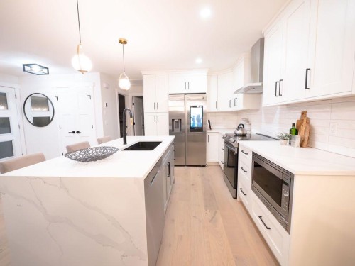 1349 Lake Sylvan Drive Se, Calgary, AB - Indoor Photo Showing Kitchen With Stainless Steel Kitchen With Double Sink With Upgraded Kitchen