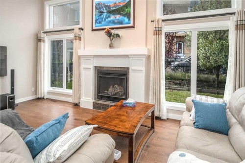 767 Shawnee Drive Sw, Calgary, AB - Indoor Photo Showing Living Room With Fireplace