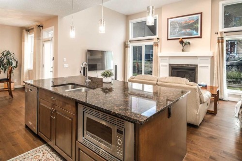 767 Shawnee Drive Sw, Calgary, AB - Indoor Photo Showing Kitchen With Fireplace With Double Sink