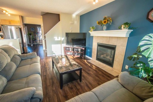 11 Saddlebrook Mews Ne, Calgary, AB - Indoor Photo Showing Living Room With Fireplace