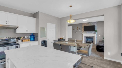 1120 Windhaven Close Sw, Airdrie, AB - Indoor Photo Showing Kitchen With Fireplace With Stainless Steel Kitchen