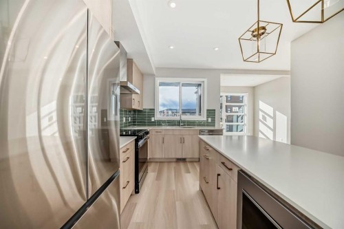 23 Lucas Way Nw, Calgary, AB - Indoor Photo Showing Kitchen With Stainless Steel Kitchen With Upgraded Kitchen