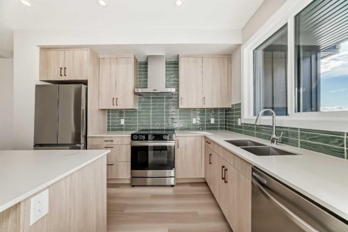 23 Lucas Way Nw, Calgary, AB - Indoor Photo Showing Kitchen With Stainless Steel Kitchen With Double Sink With Upgraded Kitchen