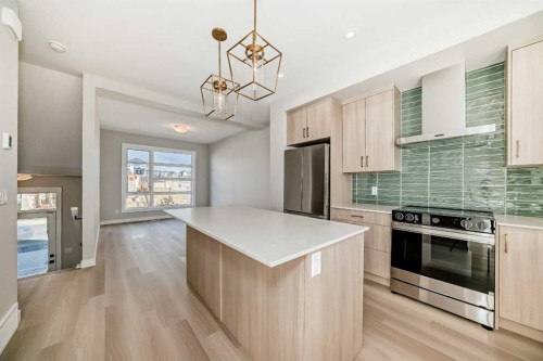 23 Lucas Way Nw, Calgary, AB - Indoor Photo Showing Kitchen With Stainless Steel Kitchen With Upgraded Kitchen