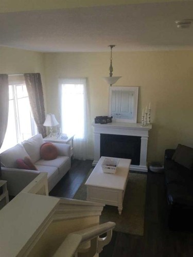 1100 Bayview Gardens Sw, Airdrie, AB - Indoor Photo Showing Living Room With Fireplace