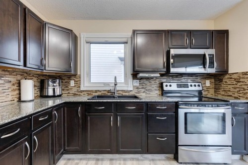 22 Hidden Spring Court Nw, Calgary, AB - Indoor Photo Showing Kitchen With Double Sink With Upgraded Kitchen