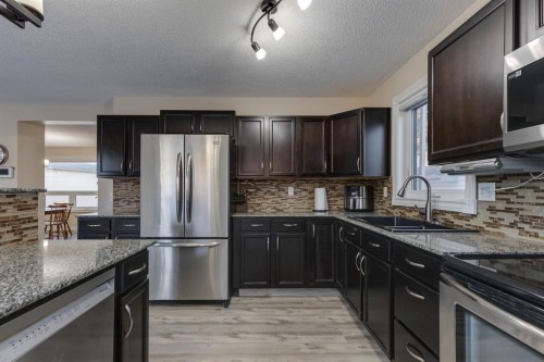 22 Hidden Spring Court Nw, Calgary, AB - Indoor Photo Showing Kitchen With Double Sink With Upgraded Kitchen