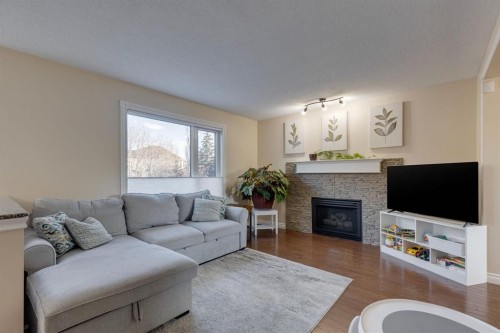 22 Hidden Spring Court Nw, Calgary, AB - Indoor Photo Showing Living Room With Fireplace