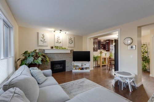 22 Hidden Spring Court Nw, Calgary, AB - Indoor Photo Showing Living Room With Fireplace