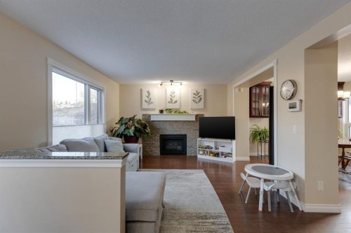22 Hidden Spring Court Nw, Calgary, AB - Indoor Photo Showing Living Room With Fireplace