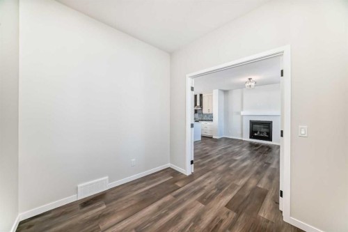 44 Ellen Lane, Crossfield, AB - Indoor Photo Showing Other Room With Fireplace