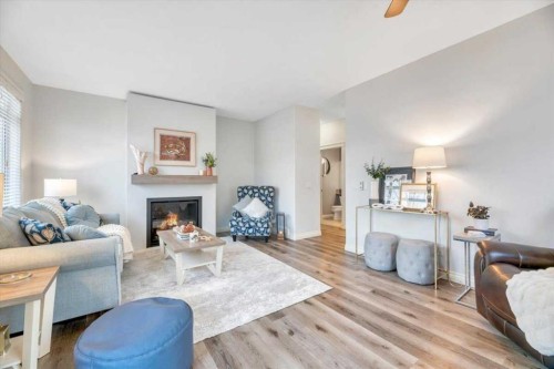 64 Discovery Woods Villas Sw, Calgary, AB - Indoor Photo Showing Living Room With Fireplace