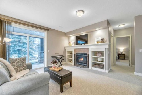 64 Discovery Woods Villas Sw, Calgary, AB - Indoor Photo Showing Living Room With Fireplace