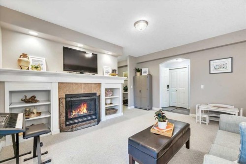 64 Discovery Woods Villas Sw, Calgary, AB - Indoor Photo Showing Living Room With Fireplace
