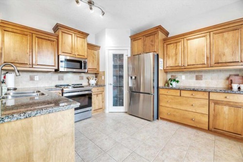 64 Discovery Woods Villas Sw, Calgary, AB - Indoor Photo Showing Kitchen With Double Sink