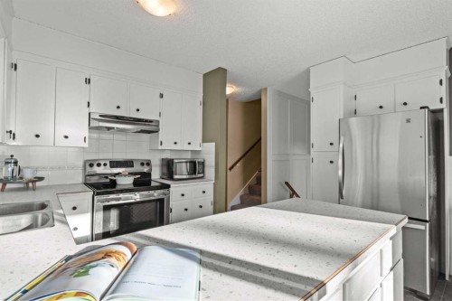 15 Beacham Rise Nw, Calgary, AB - Indoor Photo Showing Kitchen With Stainless Steel Kitchen With Double Sink