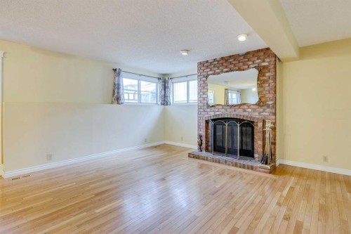 203 Edgeland Road Nw, Calgary, AB - Indoor Photo Showing Living Room With Fireplace
