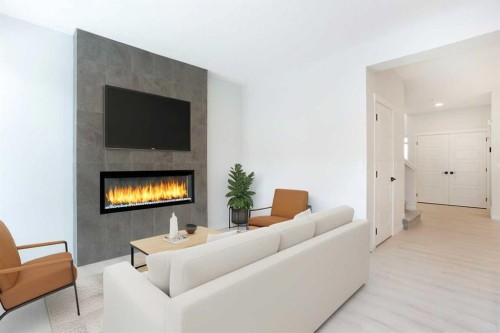 49 Creekside Passage Sw, Calgary, AB - Indoor Photo Showing Living Room With Fireplace