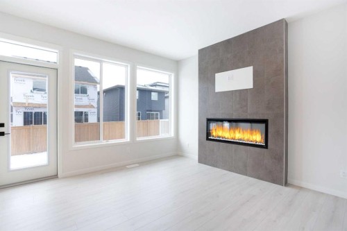 49 Creekside Passage Sw, Calgary, AB - Indoor Photo Showing Living Room With Fireplace