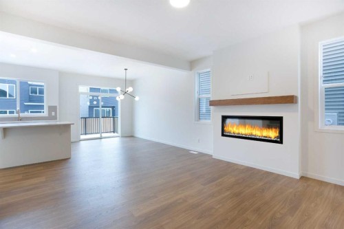 65 Creekside Passage Sw, Calgary, AB - Indoor Photo Showing Living Room With Fireplace