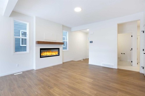 65 Creekside Passage Sw, Calgary, AB - Indoor Photo Showing Living Room With Fireplace