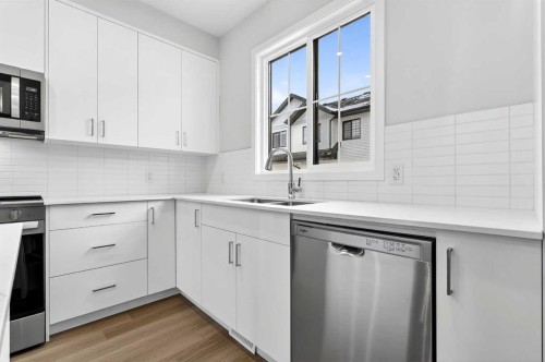 414-1750 Rangeview Drive Se, Calgary, AB - Indoor Photo Showing Kitchen With Double Sink