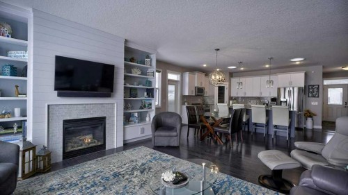 269 Boulder Creek Drive Se, Langdon, AB - Indoor Photo Showing Living Room With Fireplace