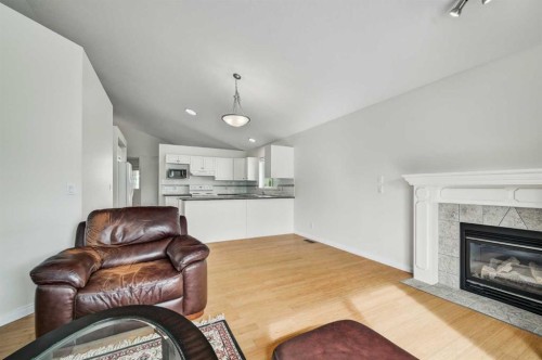 292 Arbour Crest Drive Nw, Calgary, AB - Indoor Photo Showing Living Room With Fireplace