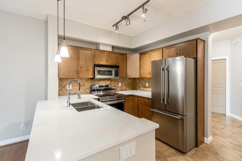 3-148 Rockyledge View Nw, Calgary, AB - Indoor Photo Showing Kitchen With Stainless Steel Kitchen With Double Sink