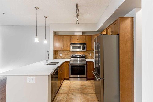 3-148 Rockyledge View Nw, Calgary, AB - Indoor Photo Showing Kitchen With Stainless Steel Kitchen With Double Sink With Upgraded Kitchen