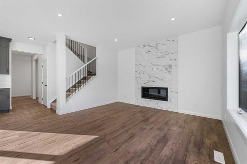 95 Dawson Wharf Mount, Chestermere, AB - Indoor Photo Showing Living Room With Fireplace