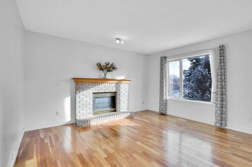 46 Somerset Close Sw, Calgary, AB - Indoor Photo Showing Living Room With Fireplace